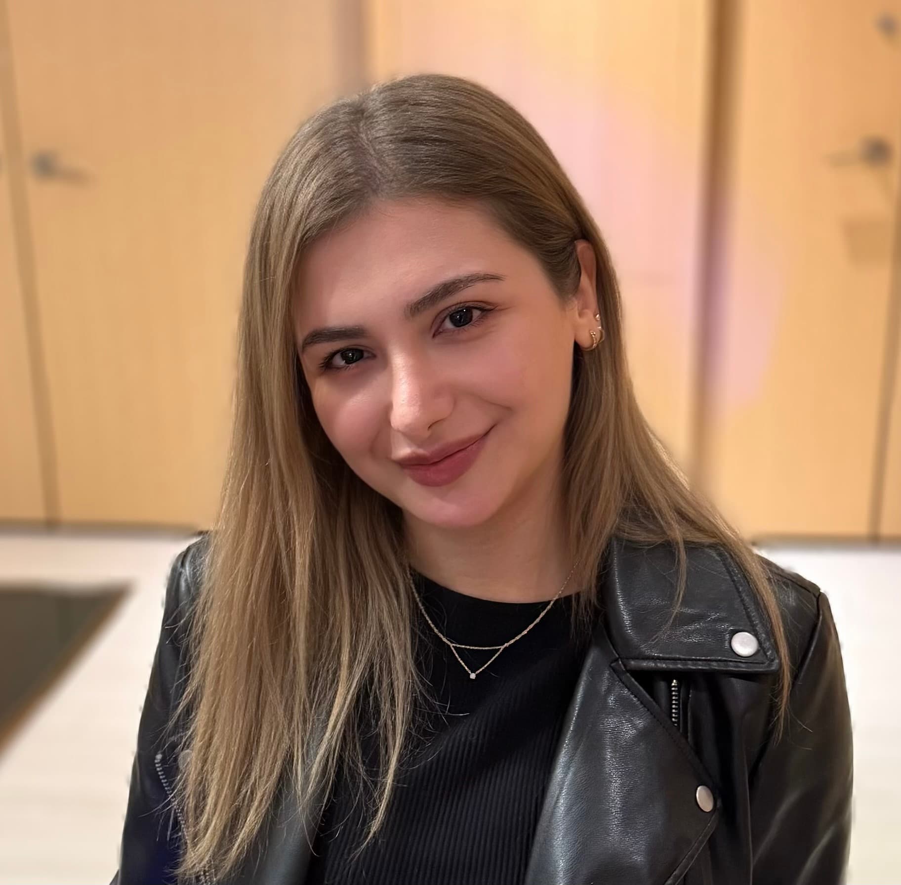 Portrait of Shaye Davoodi smiling in a black jacket.